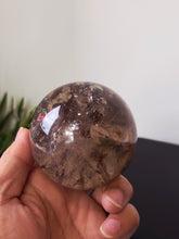 Load image into Gallery viewer, Rainbow Smokey Quartz Sphere 580g S216
